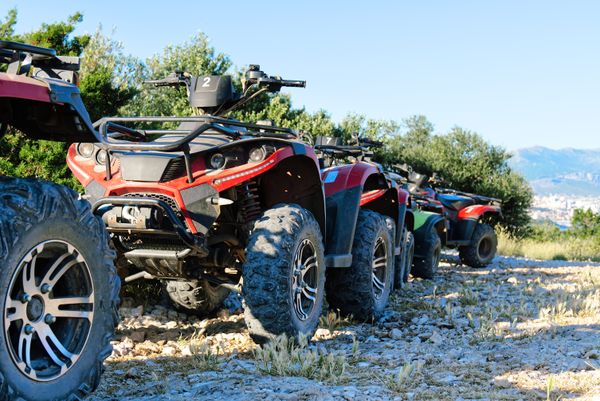 Parked ATVs and Side x Sides on mountain trail